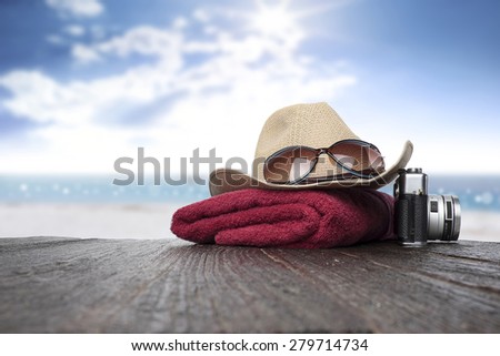 sunglasses and hat on wood desk