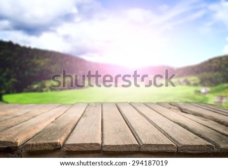wooden desk space sunny day with landscape
