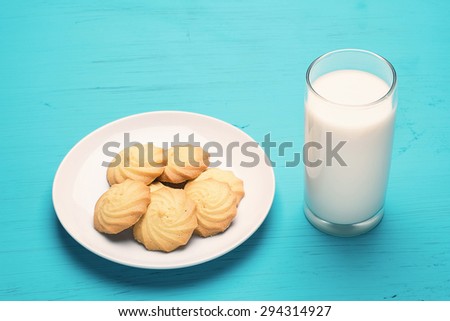 Close up of butter cookie and milk on white dish
