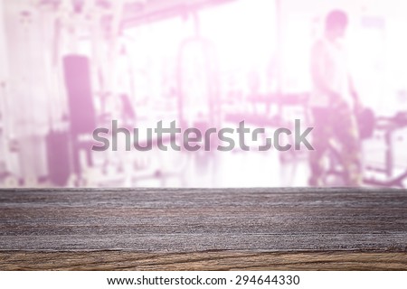 fitness gym and empty wooden table for product