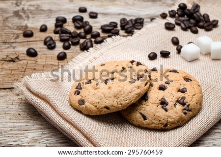 Chocolate cookies on white linen napkin on wooden table.