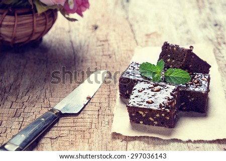 Dark chocolate and walnut brownie squares on wood desk vintage tone