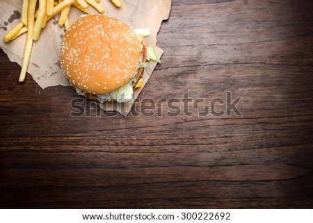 still life with fast food hamburger menu, french fries on wood desk
