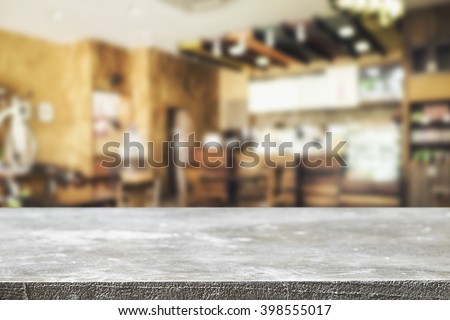 Empty wooden desk space and blurry background of restaurant vintage tone for product display montage.