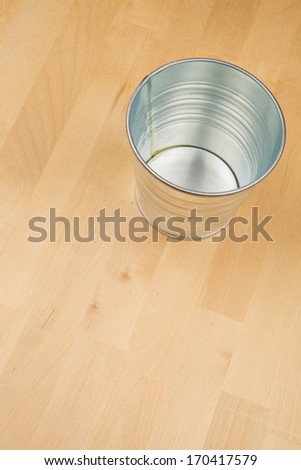 Aluminum Metal Bucket on Wood Floor