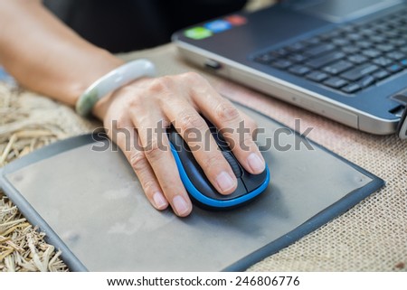 Human hand on computer mouse