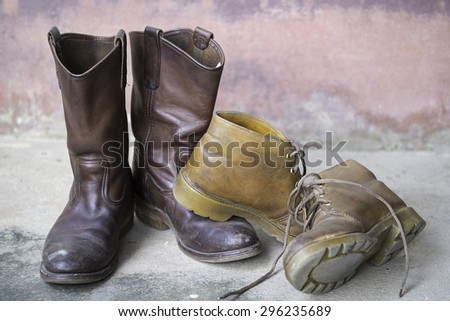 old brown leather and old yellow leather men's boots