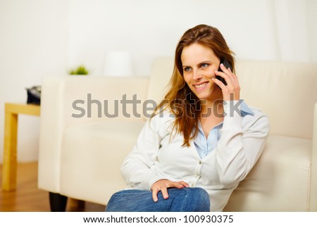 Portrait of a young friendly woman having fun on mobile phone