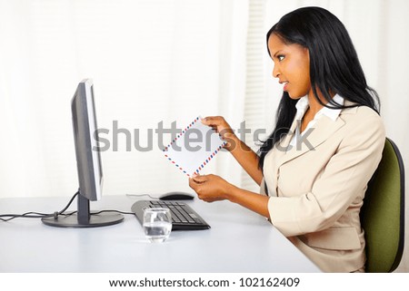 Portrait of a pretty businesswoman at work checking the mail on the computer screen