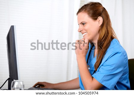 Portrait of a beautiful blonde nurse working on computer at hospital