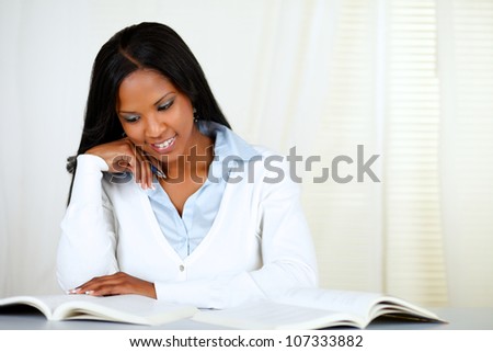 Portrait of an afro-american young black woman learning at soft colors composition