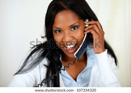 Close up portrait of a charming young woman speaking on phone