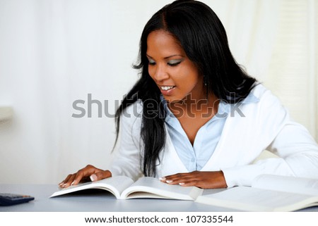 Portrait of a beautiful black girl studying at soft colors composition