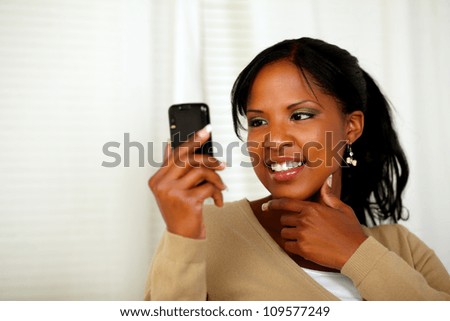 Portrait of a sophisticated woman reading a message on cellphone