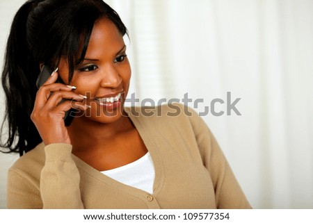 Portrait of a beautiful black woman conversing on mobile phone