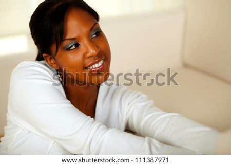 Portrait of a young afro-American woman looking to her left. With copyspace