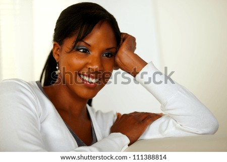 Portrait of a relaxed young woman sitting on couch at home indoor