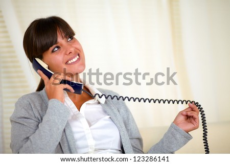 Portrait of a young woman looking up speaking on phone - copyspace