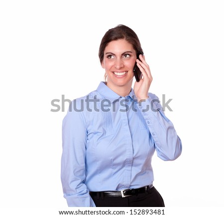 A portrait of a beautiful woman on blue blouse talking on her cellphone and smiling on isolated background - copyspace