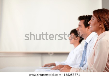 Portrait of senior coworker group looking at a presentation on office background - copyspace