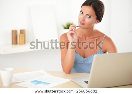 Smart lovely woman in blue blouse studying in her room using the computer - copyspace