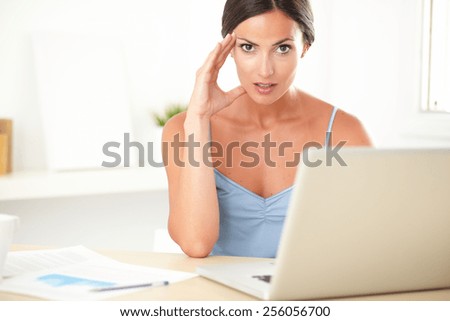 Stylish female in blue blouse feeling tension at work
