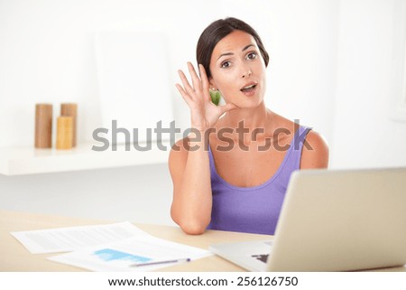 Lovely latin female in purple shirt studying on her computer and looking happy - copyspace