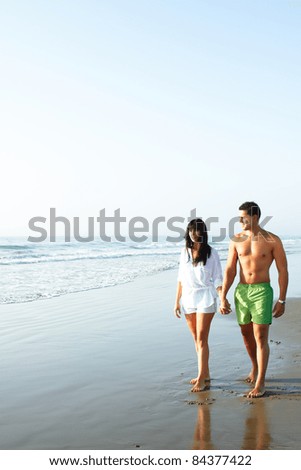 portrait of a  cute couple walking along the seashore