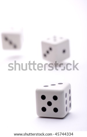 three dice thrown into the air trying their luck