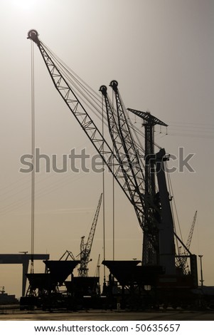 a port cranes working in the early morning hours
