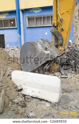 a huge machine demolition, tearing down a football stadium