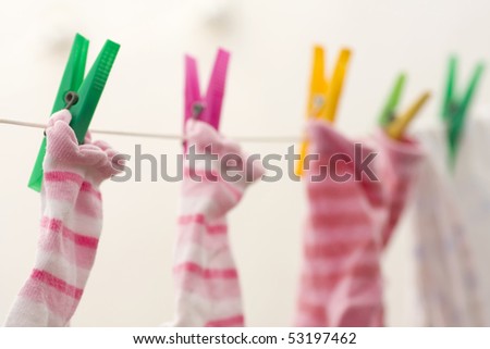 several different colored socks, hanging out to dry