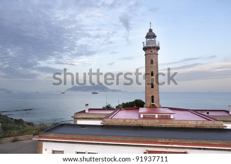 the lighthouse on the bay of Algeciras (Spain), and behind the narrow Gibraltar (England)