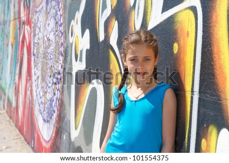 beautiful girl on a background of graffiti