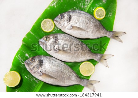 Dorado fish with lemon on a banana leaf
