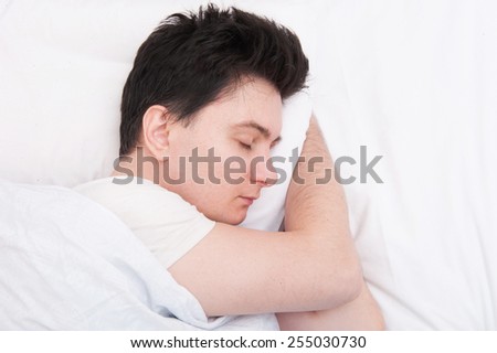 Man sleeping in his bed