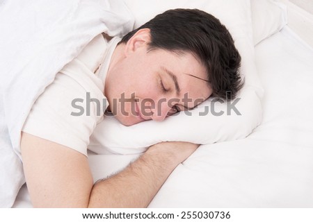 Man sleeping in his bed