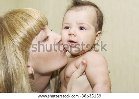 Mother kissing baby