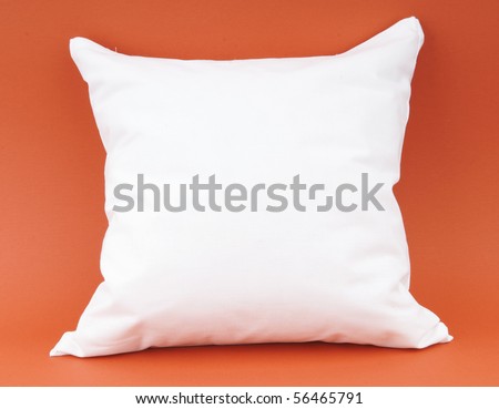 white pillow on an orange background