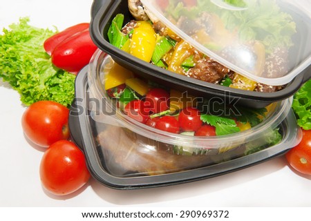 Lunch box with Chinese food and vegetables