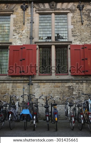 Bicycles parked at bike rack in front of an old building