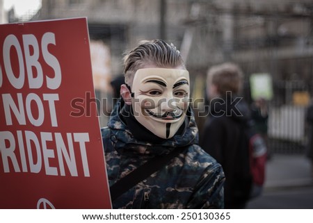 LONDON - JANUARY 24, 2015: Unidentified anarchist wearing a Guy Fawkes mask protests against the proposed Â£100bn 