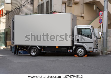 Japan Cargo truck with a blank container for Mockup parking in front of building background