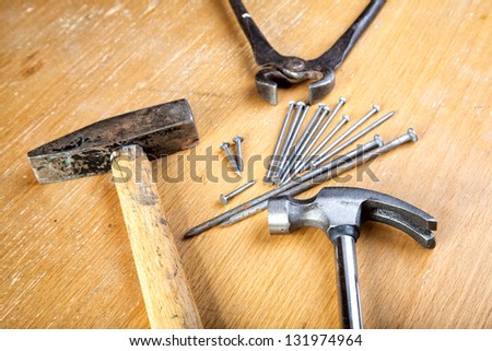Hammers   pincers and nails on a wooden table