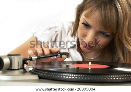The girl listens to a phonograph record