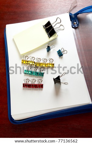 folder sheets and paper clips on a desk