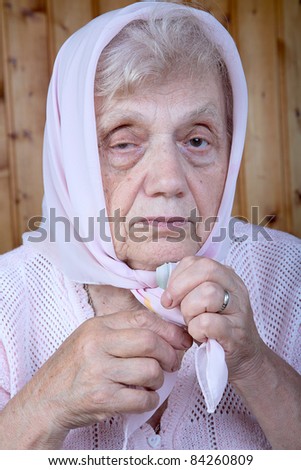 Portrait of the old woman in a kerchief close up