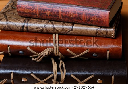 Pile of notebooks in leather covers close up