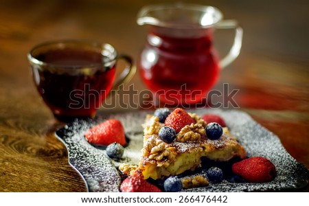 slice of apple pie with strawberries, blueberries,walnut, teacup and glass  kettle