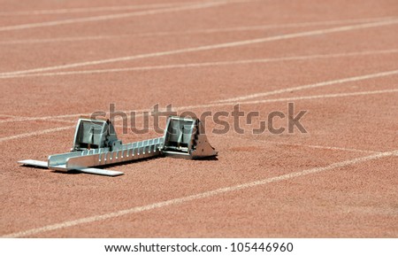 Athletics starting block on a stadium tartan.